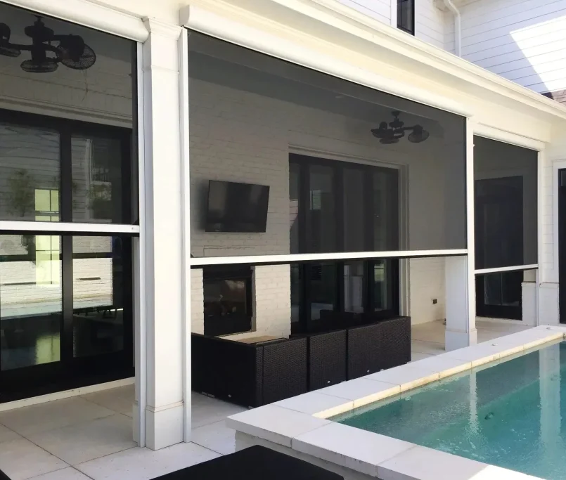 Custom retractable screens enclosing porch and pool area by Retracta Screens of the Carolinas