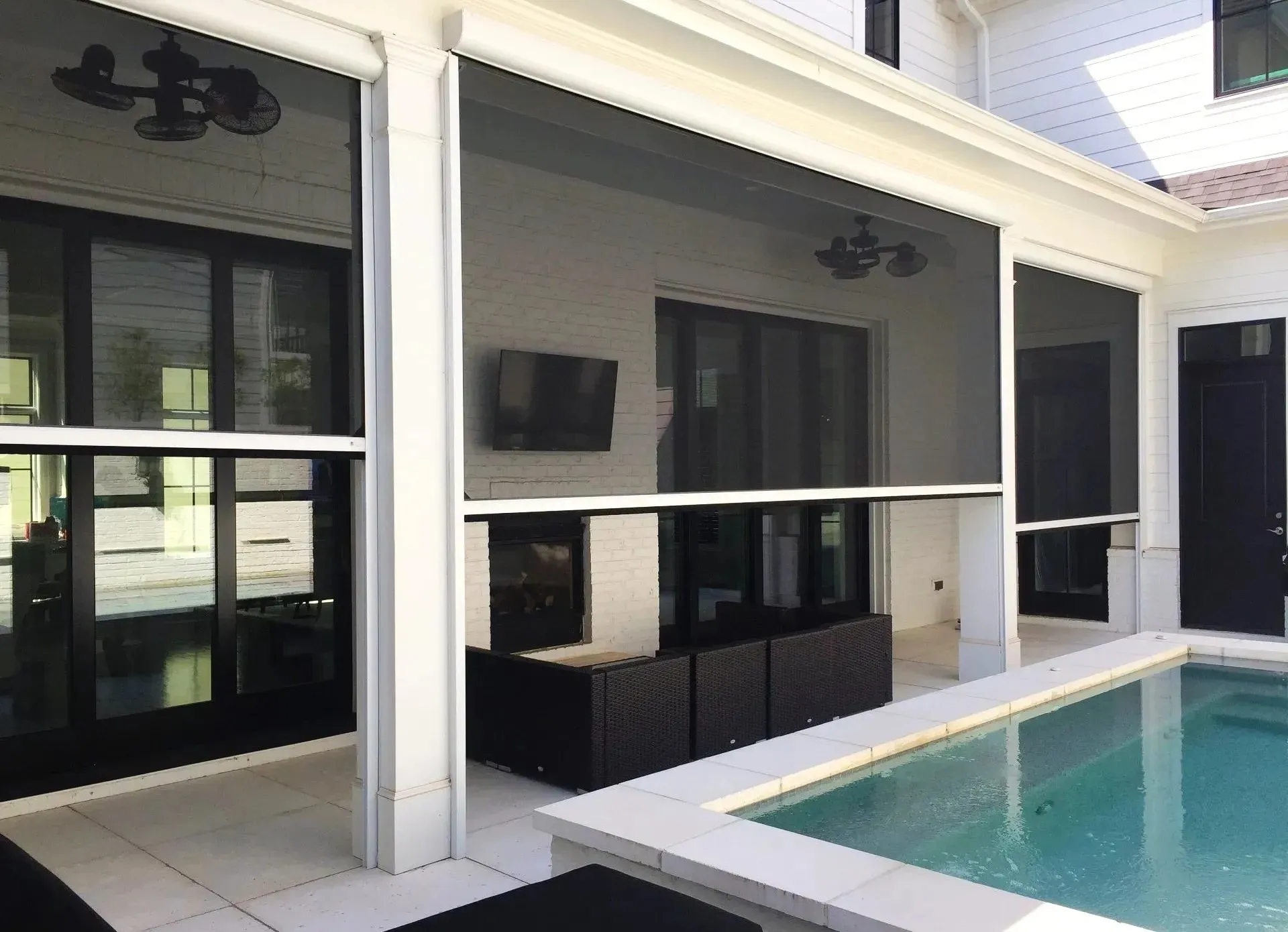 Custom retractable screens enclosing porch and pool area by Retracta Screens of the Carolinas